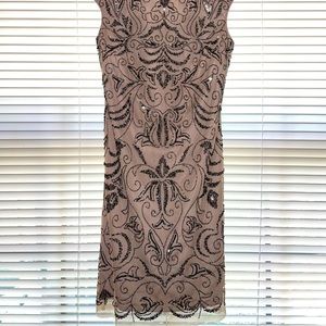 Off cream/gray color. Embellished. Very elegant. Wears well.